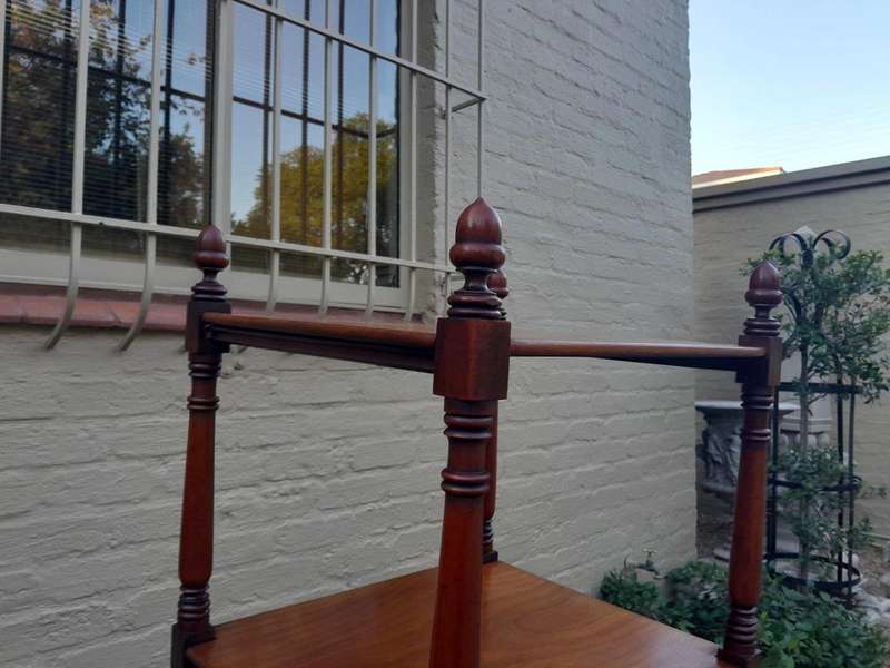 A 20th Century Mahogany Display Stand With Castors