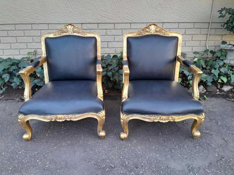A 20th Century Near Pair  Of Victorian Style Hand-Gilded Mahogany Armchairs And Ottomans Upholst...