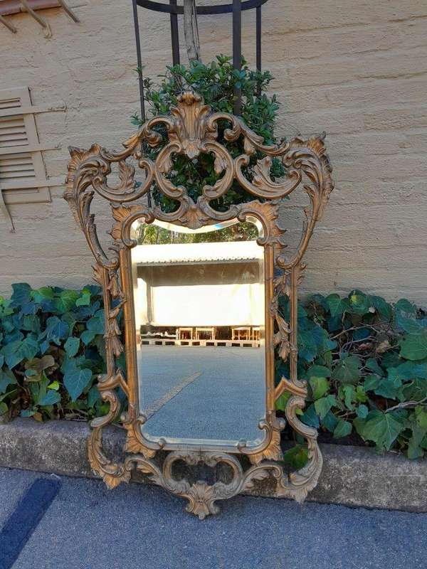 A 20th Century French Style Ornately Carved And Gilt Painted Wooden Mirror