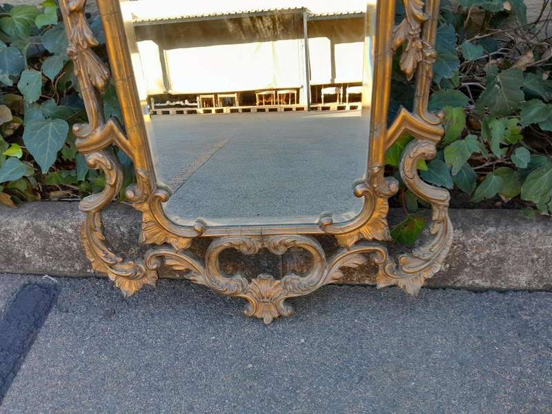 A 20th Century French Style Ornately Carved And Gilt Painted Wooden Mirror