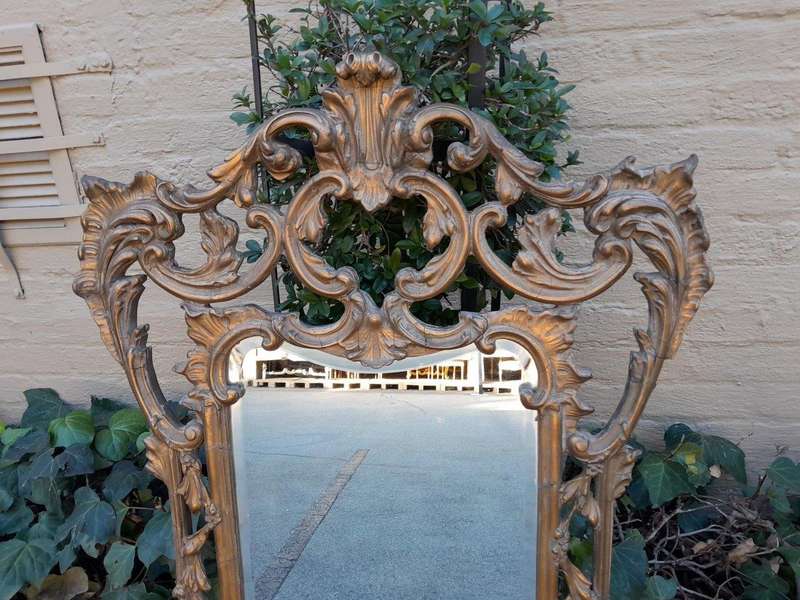 A 20th Century French Style Ornately Carved And Gilt Painted Wooden Mirror