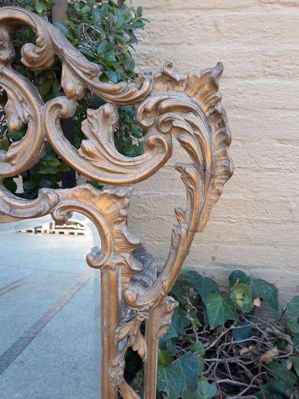 A 20th Century French Style Ornately Carved And Gilt Painted Wooden Mirror