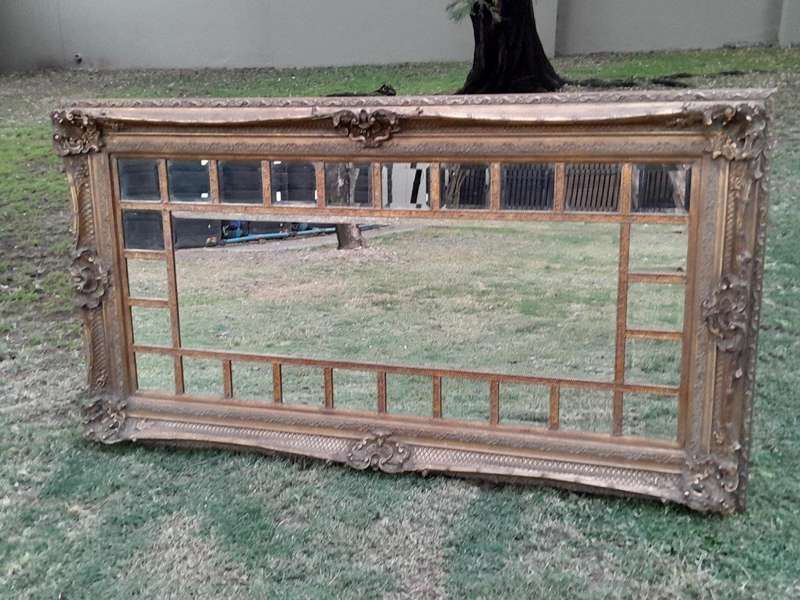 A 20th Century French Style Ornately Carved, Gilt Painted And Bevelled Mirror Of Large Proportions