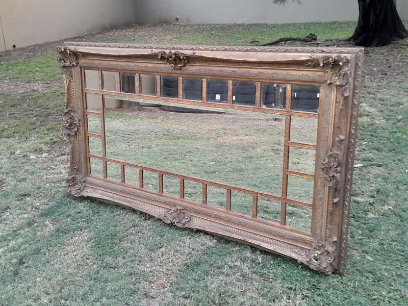 A 20th Century French Style Ornately Carved, Gilt Painted And Bevelled Mirror Of Large Proportions