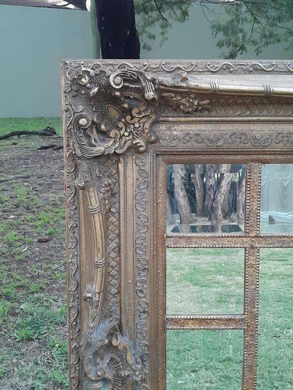 A 20th Century French Style Ornately Carved, Gilt Painted And Bevelled Mirror Of Large Proportions