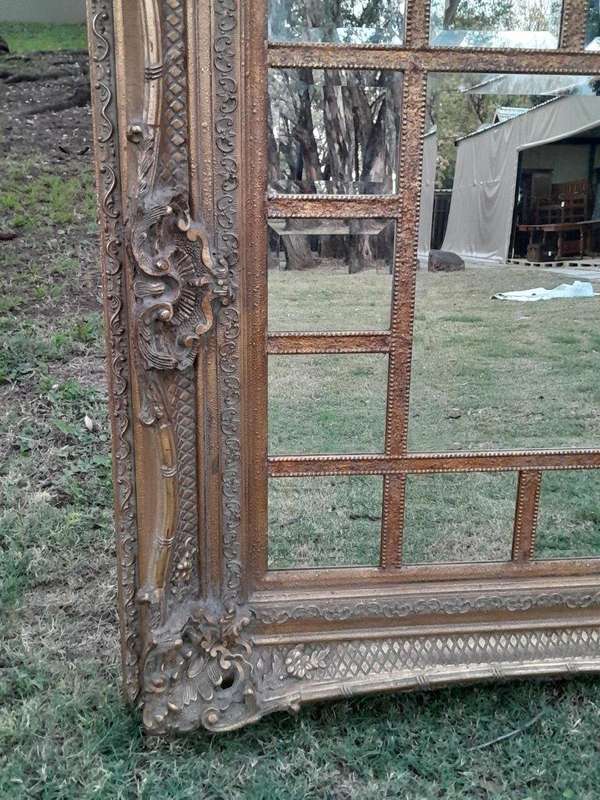 A 20th Century French Style Ornately Carved, Gilt Painted And Bevelled Mirror Of Large Proportions