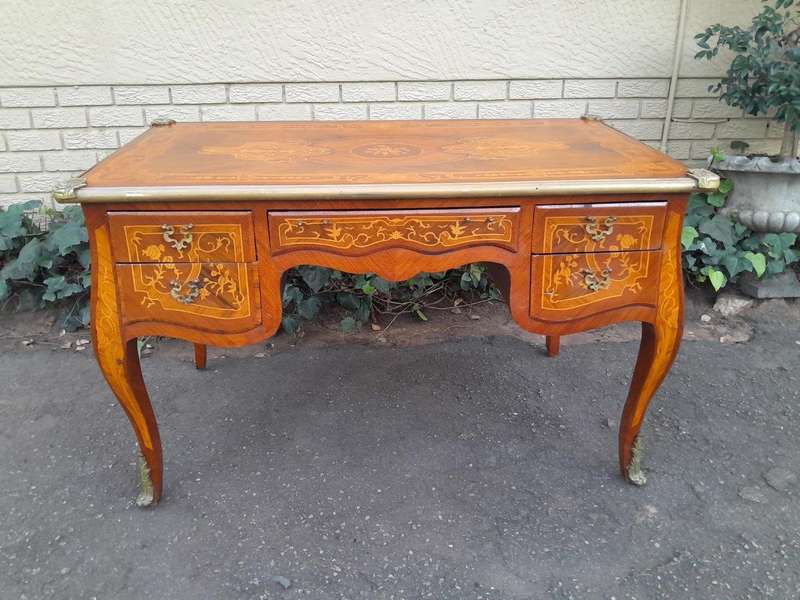 A 20th Century French Style Mahogany And Mahogany Marquetry Inlaid Desk With Brass Caps And Drawers