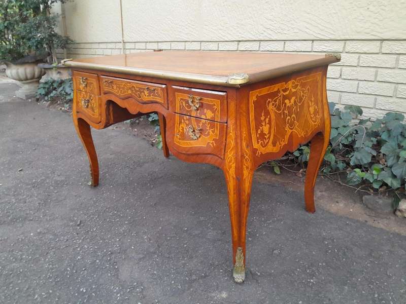 A 20th Century French Style Mahogany And Mahogany Marquetry Inlaid Desk With Brass Caps And Drawers