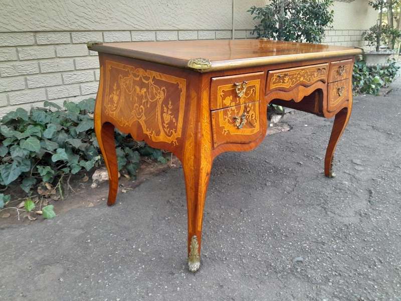 A 20th Century French Style Mahogany And Mahogany Marquetry Inlaid Desk With Brass Caps And Drawers