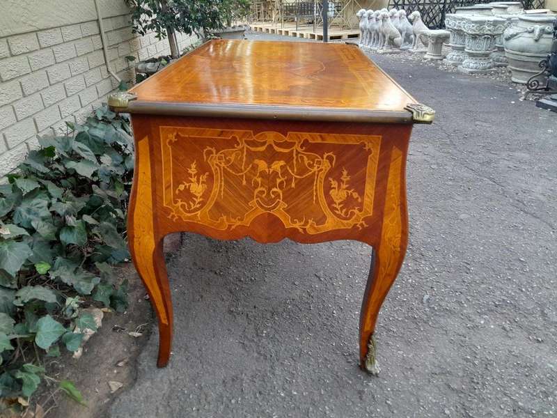 A 20th Century French Style Mahogany And Mahogany Marquetry Inlaid Desk With Brass Caps And Drawers