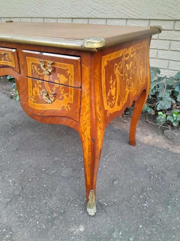 A 20th Century French Style Mahogany And Mahogany Marquetry Inlaid Desk With Brass Caps And Drawers