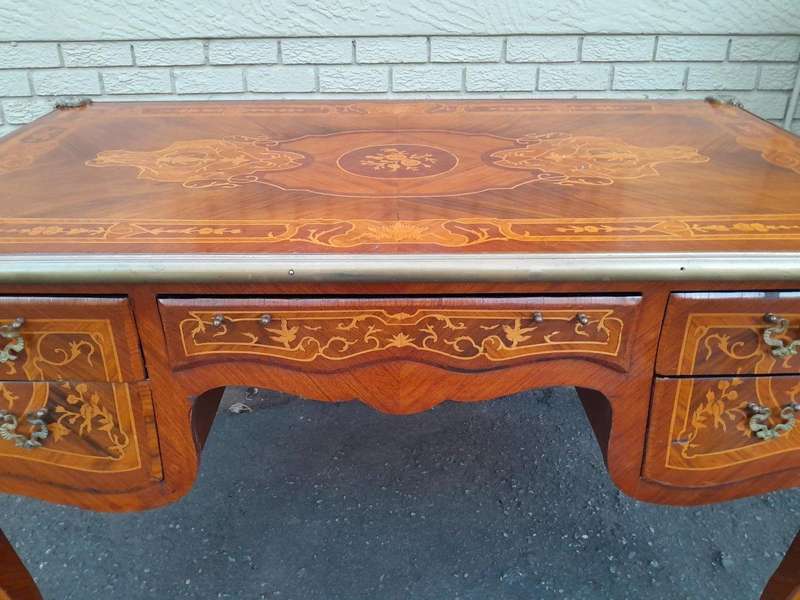 A 20th Century French Style Mahogany And Mahogany Marquetry Inlaid Desk With Brass Caps And Drawers