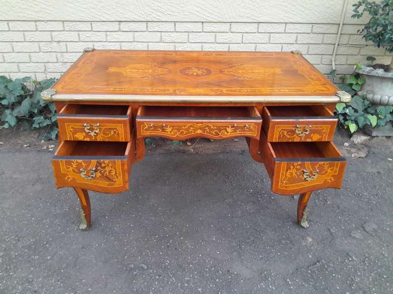 A 20th Century French Style Mahogany And Mahogany Marquetry Inlaid Desk With Brass Caps And Drawers
