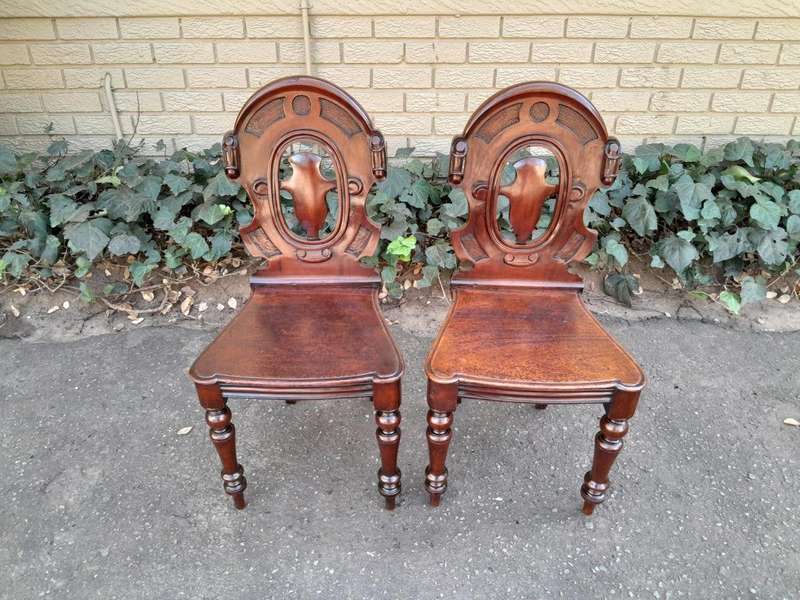 A  20TH Century Pair  of Victorian Carved Mahogany Hall Chairs