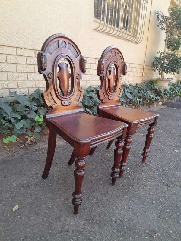 A  20TH Century Pair  of Victorian Carved Mahogany Hall Chairs