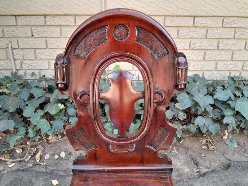 A  20TH Century Pair  of Victorian Carved Mahogany Hall Chairs