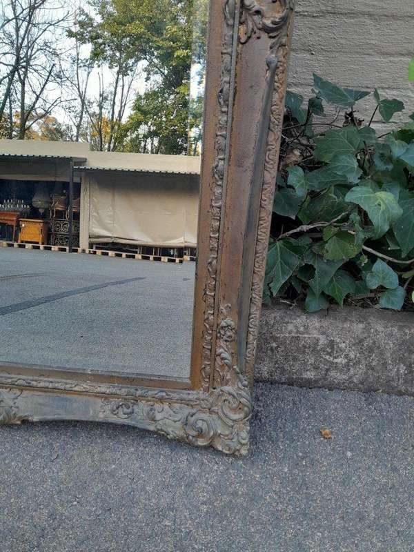 A 20th Century Large And Ornately Carved Gilded And Bevelled Mirror