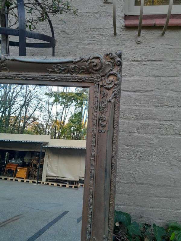 A 20th Century Large And Ornately Carved Gilded And Bevelled Mirror