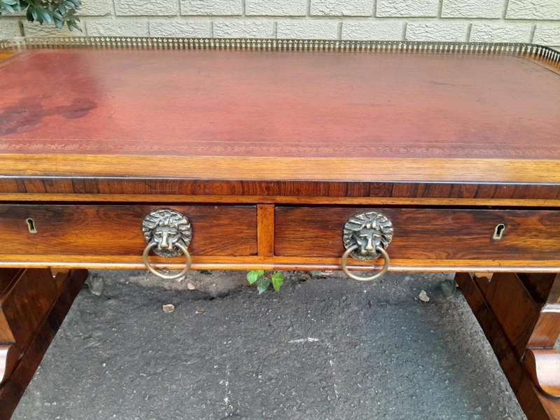 A 19th Century William IV Rosewood Desk with Gilt Tooled Leather and Gilt Metal Gallery Top on Br...