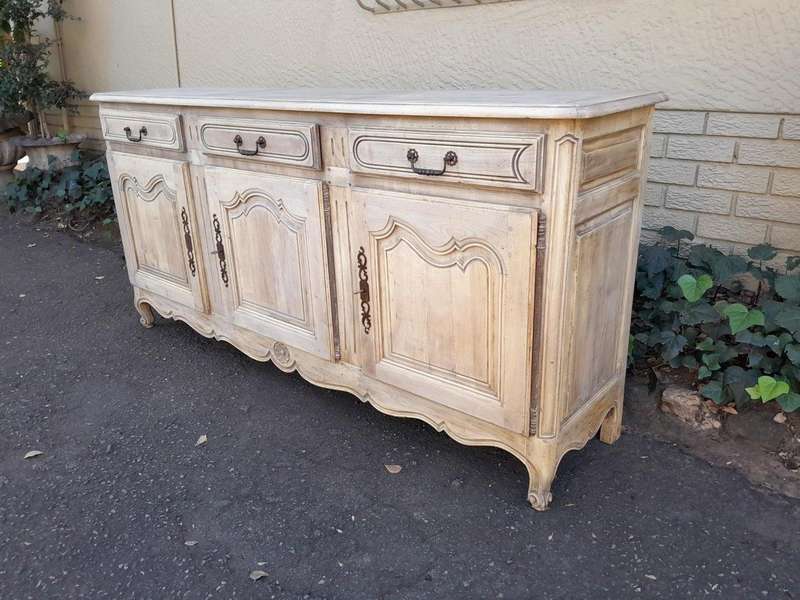 A 20TH Century French Walnut Sideboard with Original Iron hinges in a Contemporary Bleached Finish