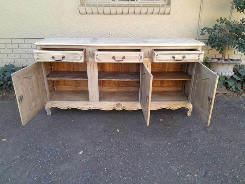 A 20TH Century French Walnut Sideboard with Original Iron hinges in a Contemporary Bleached Finish