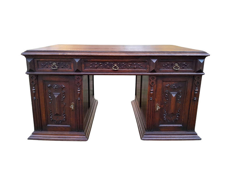 A 20th Century Ornately Carved Oak Pedestal Desk with Drawers
