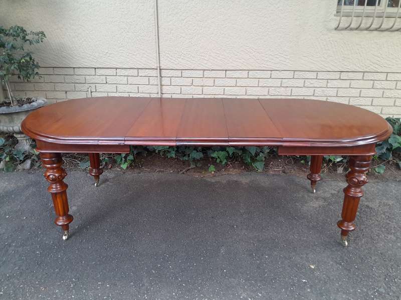 A 19th Century Antique Victorian Mahogany Extending Dining Table with Heavily Carved Legs on Bras...