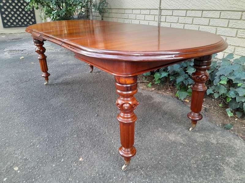 A 19th Century Antique Victorian Mahogany Extending Dining Table with Heavily Carved Legs on Bras...