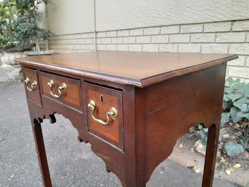 An 18th/ 19th Century Georgian Oak and Mahogany Lowboy with Drawers and Brass Handles