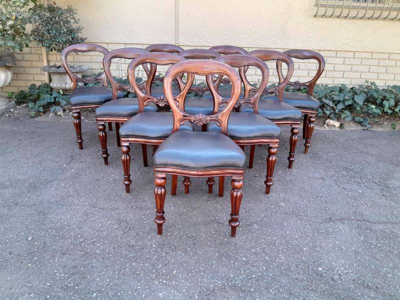 An Early 20th Century Victorian Set Of Ten Bustle Back Chairs Upholstered In Deep Button Leather