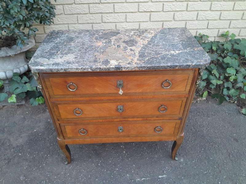 An Antique Kingswood and Gilt Metal Mounted Chest of Drawers with Marble Top