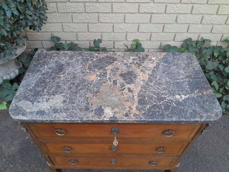 An Antique Kingswood and Gilt Metal Mounted Chest of Drawers with Marble Top