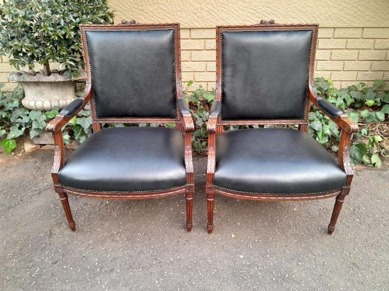 A 19th Century French Pair of Carved Walnut Armchairs Upholstered in  Leather