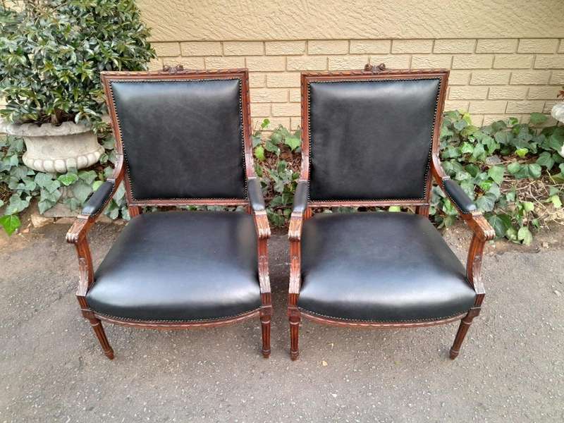 A 19th Century French Pair of Carved Walnut Armchairs Upholstered in  Leather