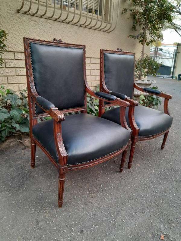 A 19th Century French Pair of Carved Walnut Armchairs Upholstered in  Leather