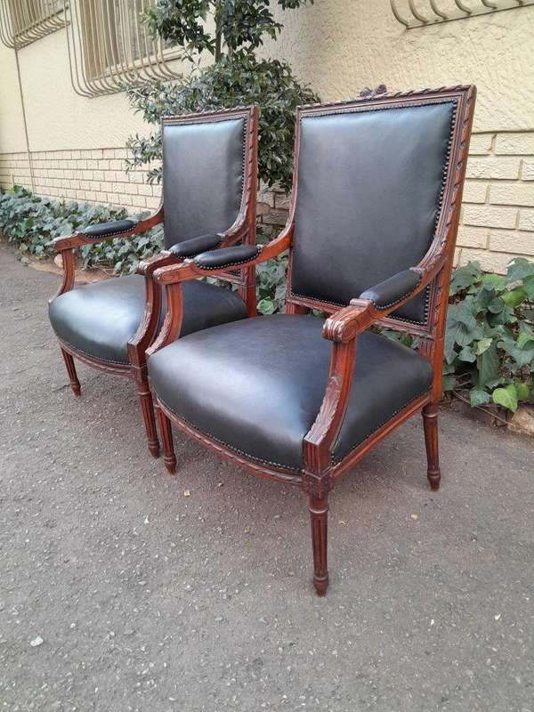 A 19th Century French Pair of Carved Walnut Armchairs Upholstered in  Leather