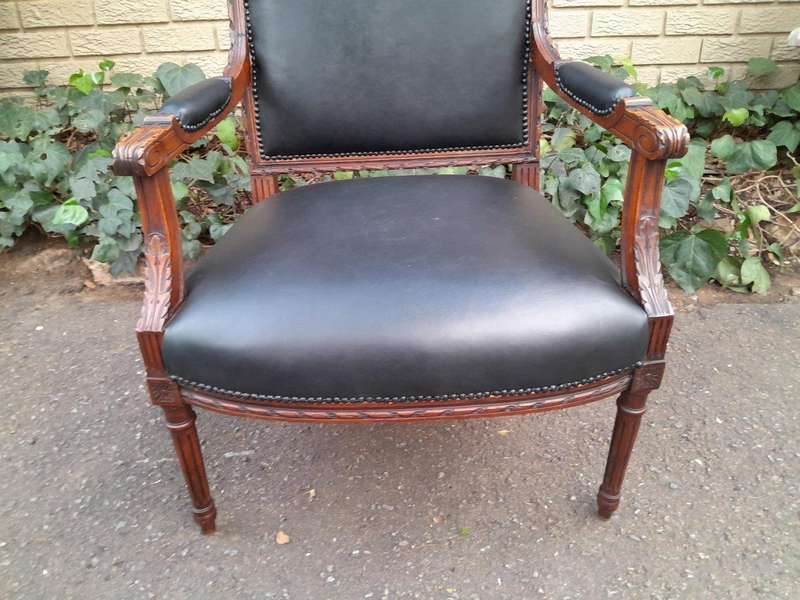 A 19th Century French Pair of Carved Walnut Armchairs Upholstered in  Leather