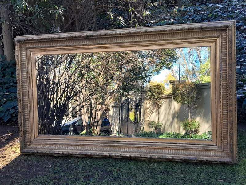 A 19th Century Carved Giltwood And Gesso Mirror Of Large Proportions