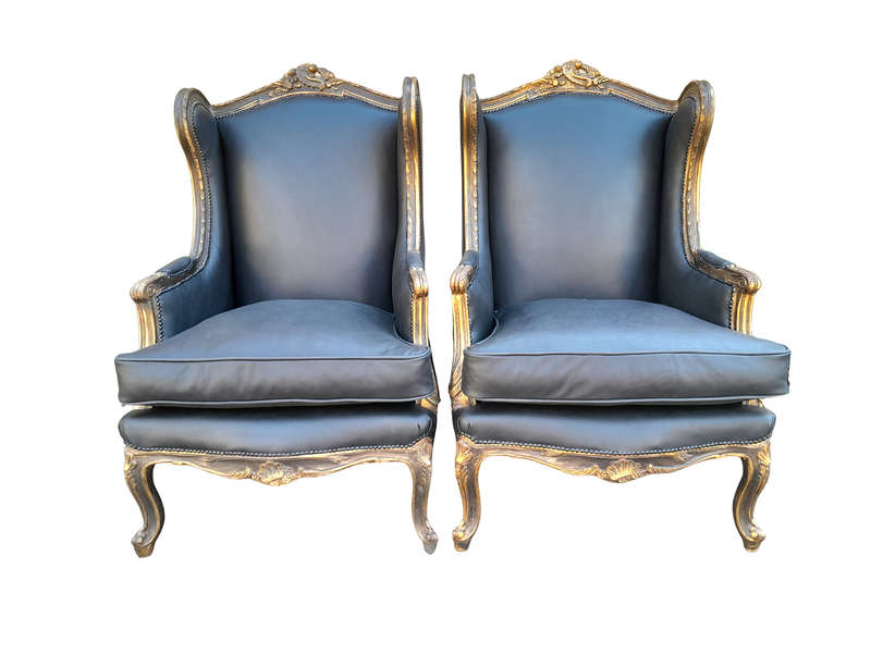 A Circa 1900s French Style Pair Of Carved Giltwood Wingback Chairs Upholstered In Leather