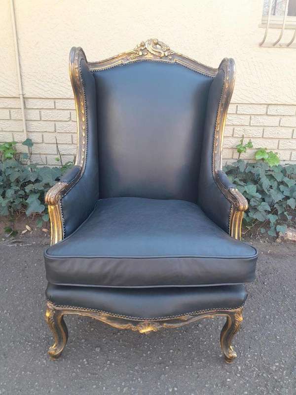 A Circa 1900s French Style Pair Of Carved Giltwood Wingback Chairs Upholstered In Leather