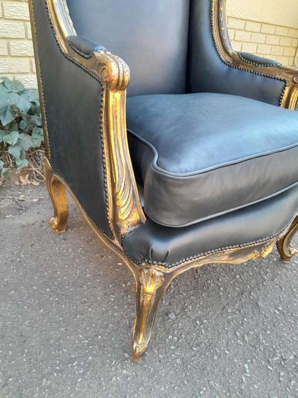 A Circa 1900s French Style Pair Of Carved Giltwood Wingback Chairs Upholstered In Leather