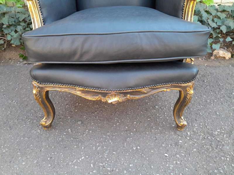 A Circa 1900s French Style Pair Of Carved Giltwood Wingback Chairs Upholstered In Leather