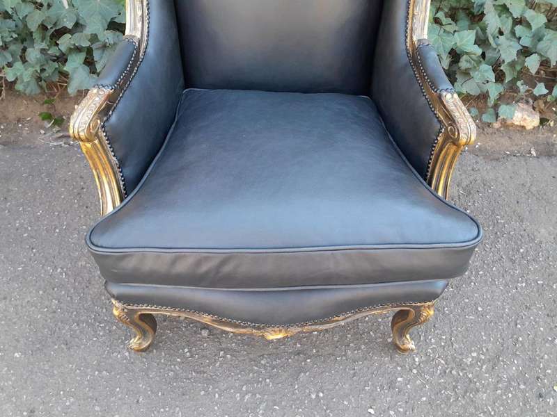 A Circa 1900s French Style Pair Of Carved Giltwood Wingback Chairs Upholstered In Leather