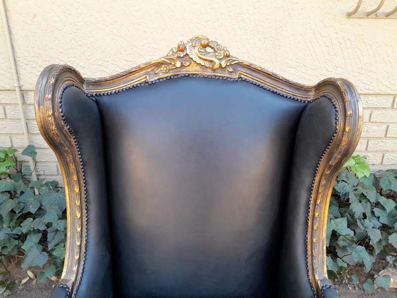 A Circa 1900s French Style Pair Of Carved Giltwood Wingback Chairs Upholstered In Leather
