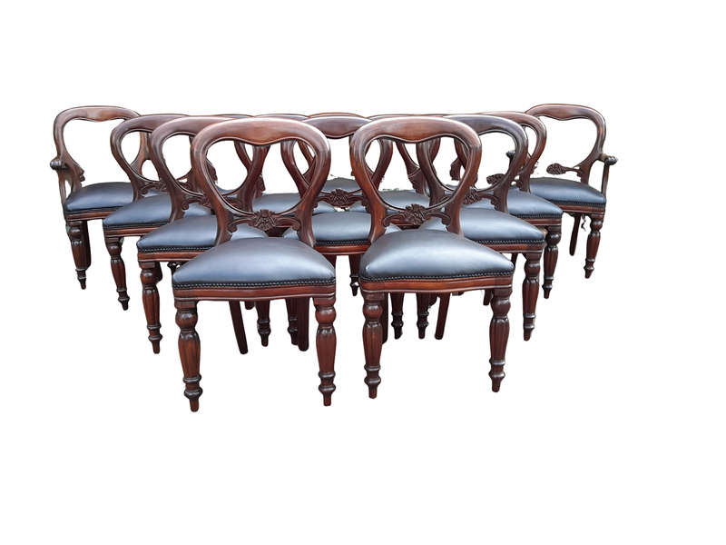 A 20th Century Set of Fourteen (14) Victorian Style Mahogany Bustle Back Chairs Upholstered in Le...