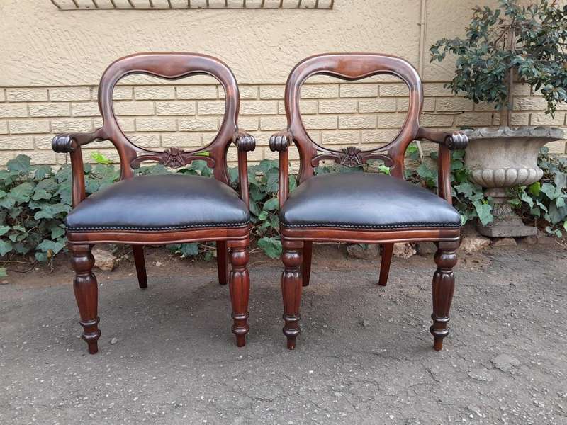 A 20th Century Set of Fourteen (14) Victorian Style Mahogany Bustle Back Chairs Upholstered in Le...