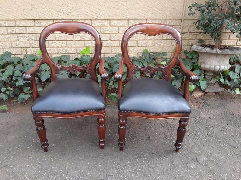 A 20th Century Set of Fourteen (14) Victorian Style Mahogany Bustle Back Chairs Upholstered in Le...