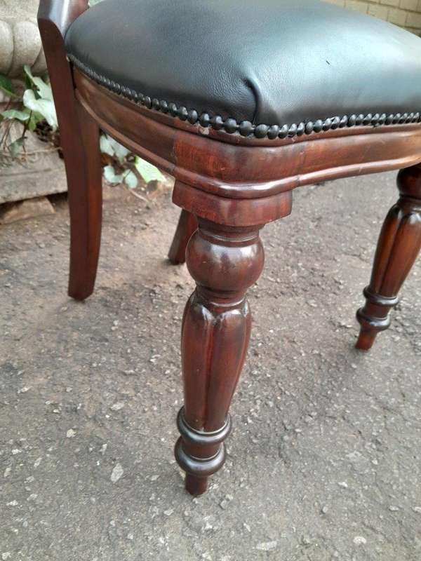 A 20th Century Set of Fourteen (14) Victorian Style Mahogany Bustle Back Chairs Upholstered in Le...