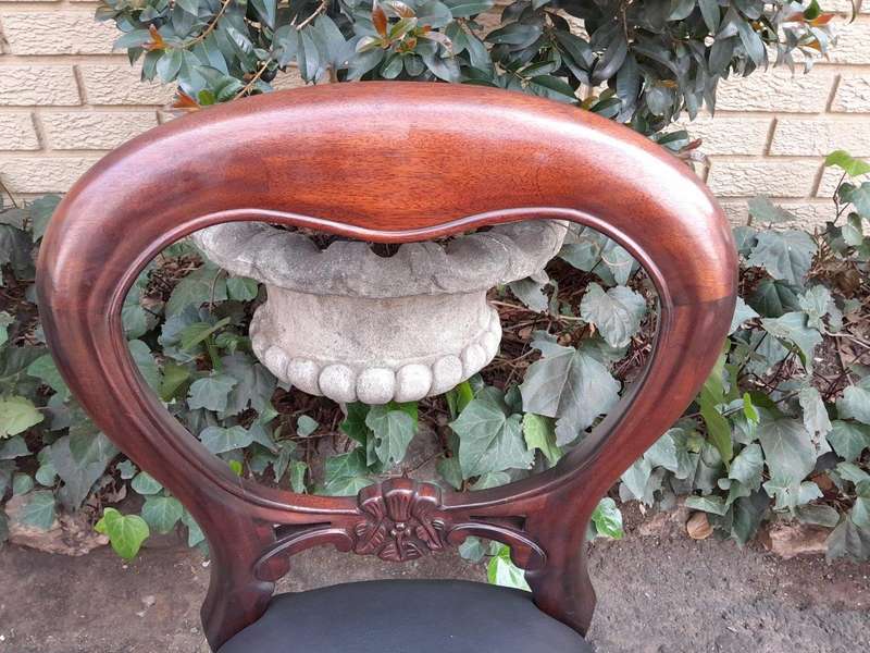 A 20th Century Set of Fourteen (14) Victorian Style Mahogany Bustle Back Chairs Upholstered in Le...
