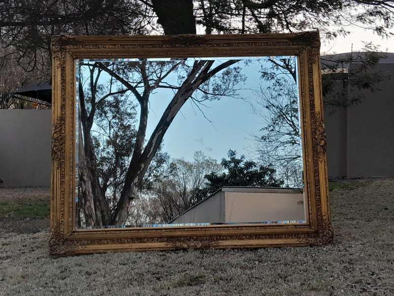 A Massive 20TH Century French Style Ornately Carved And Gilded Bevelled Mirror Of Large Proportions